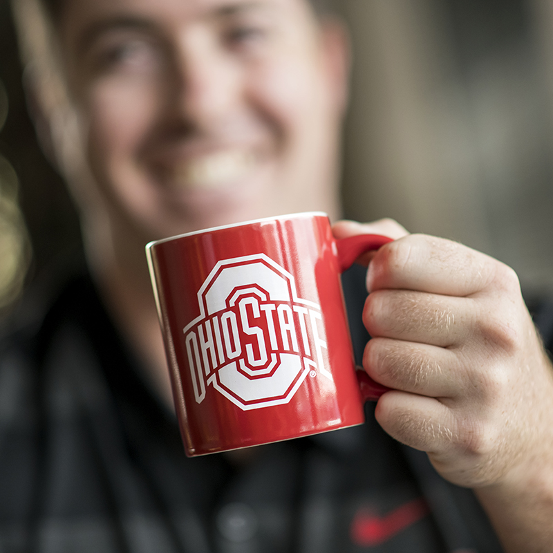 Student holding an Ohio State coffee mug