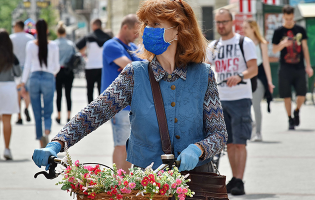 Woman with flowers wearing mask