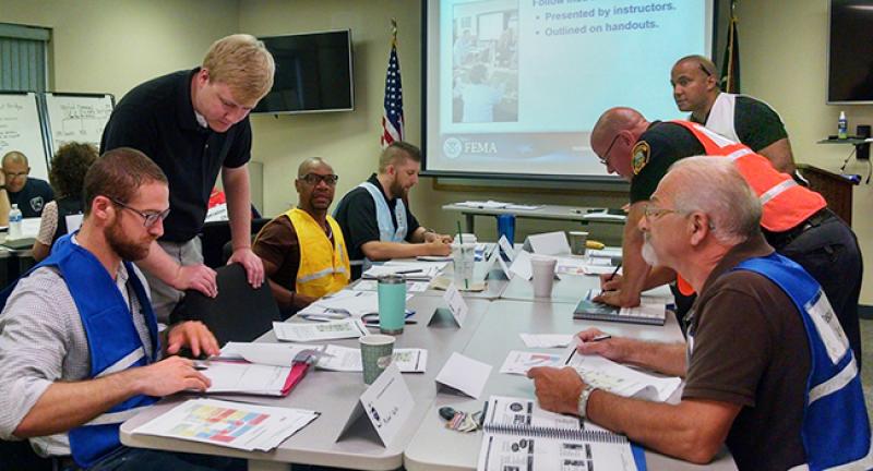 Alex McCarthy, director of the Tuscarawas County Homeland Security and Emergency Management Agency, interacting with health officials and first responders during an exercise.