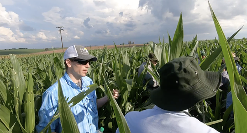 Bart Elmore at a corn field in Brazil with farmers.