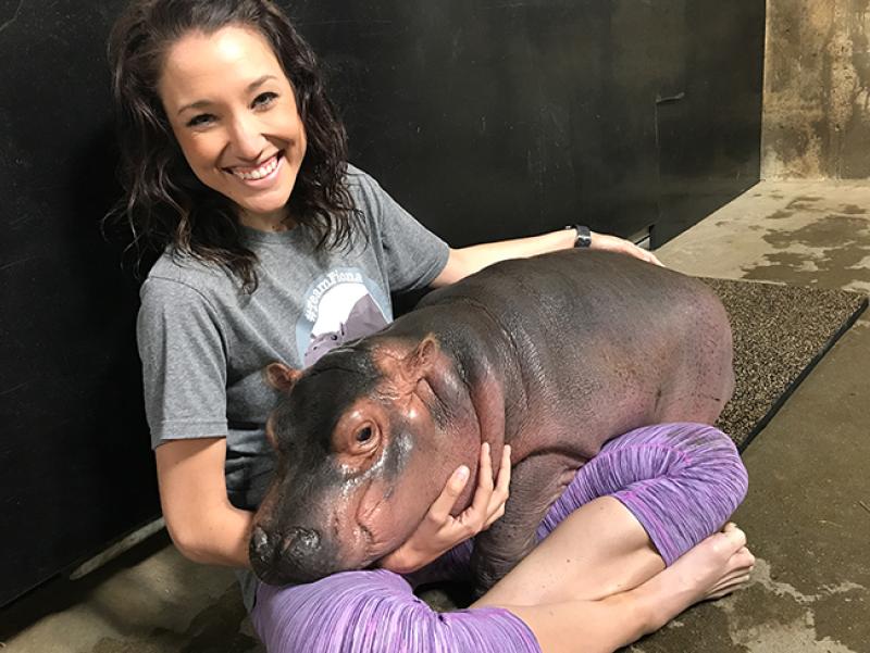 Arts and Sciences alumna Angela Hatke with Fiona the baby hippo.