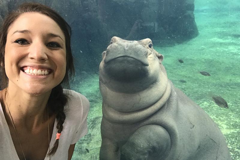 Arts and Sciences alumna Angela Hatke with Fiona the baby hippo