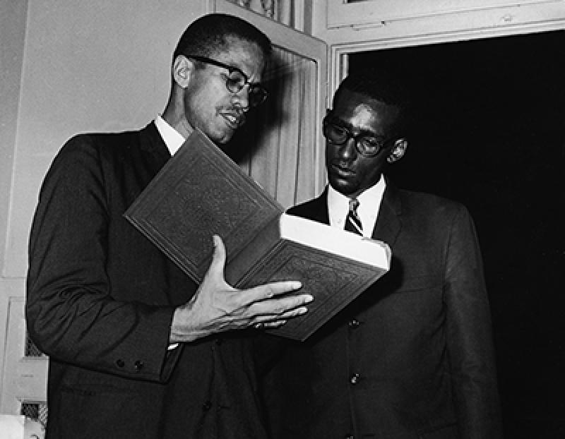 Malcolm X reading the Quran
