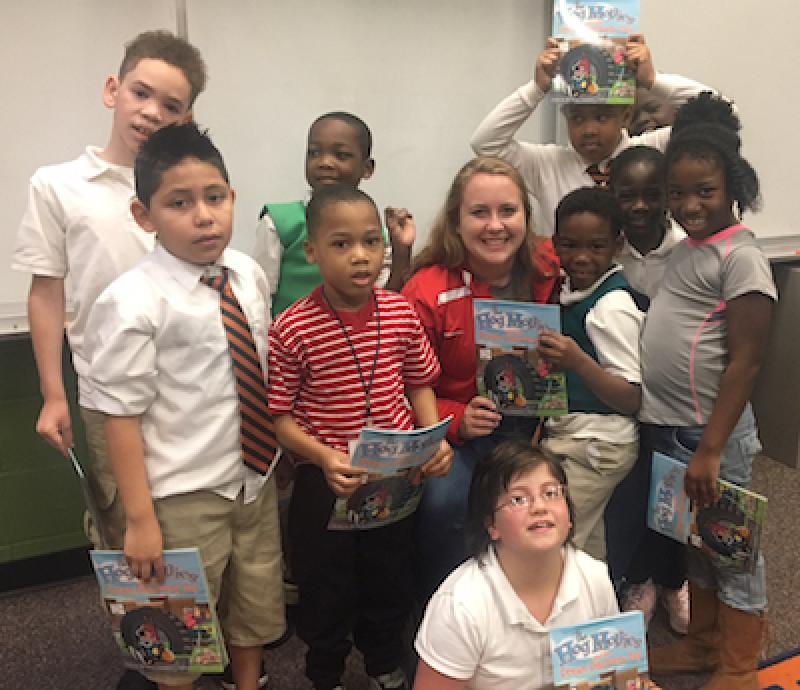 Kelsey Crawford (center) poses with students after a reading