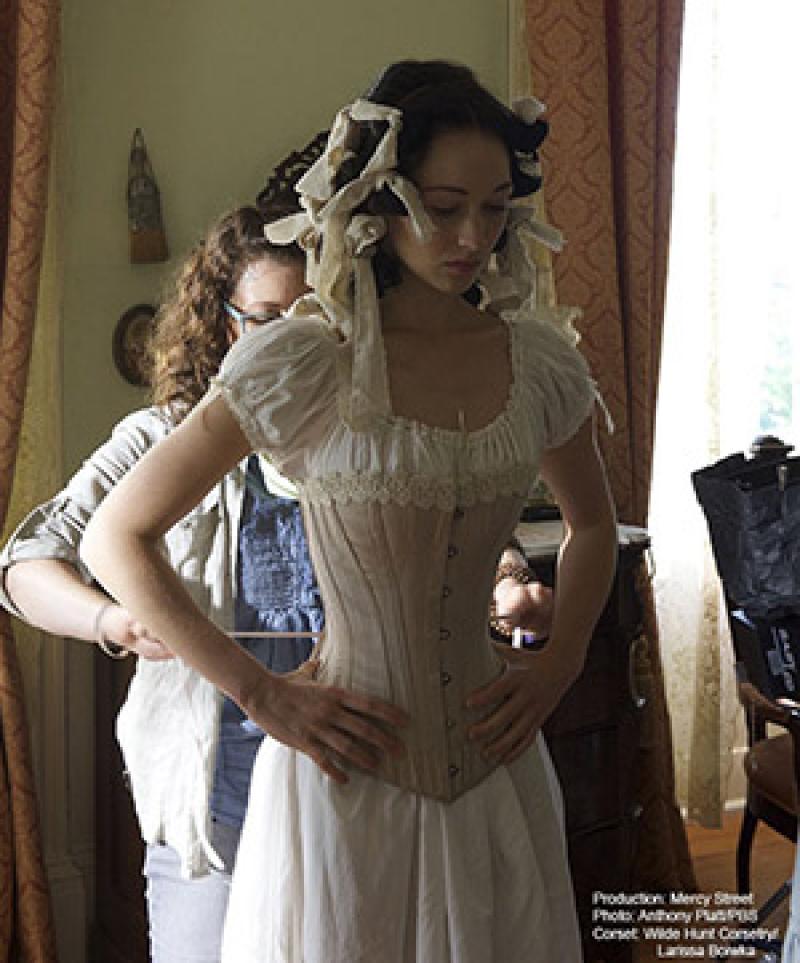 Actress Hannah James gets fitted in one of Boiwka's corset on the set of PBS's "Mercy Street"