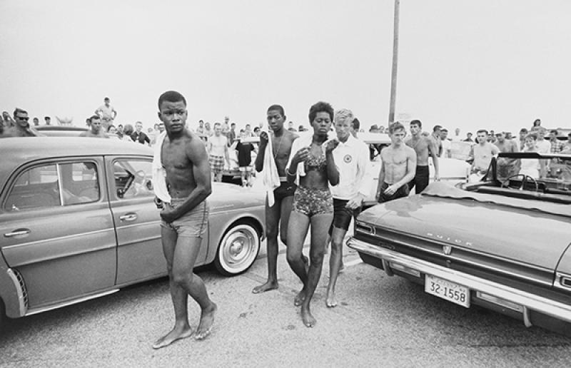 A jeering crowd follows three Black youths in 1963