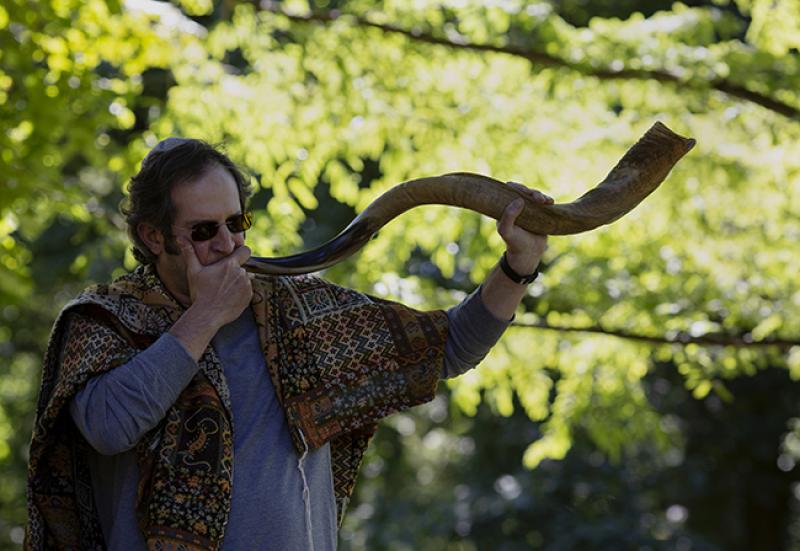 Blowing a shofar during an outdoor Rosh Hashanah ceremony in Bexley. Photo: Lauren Pond 
