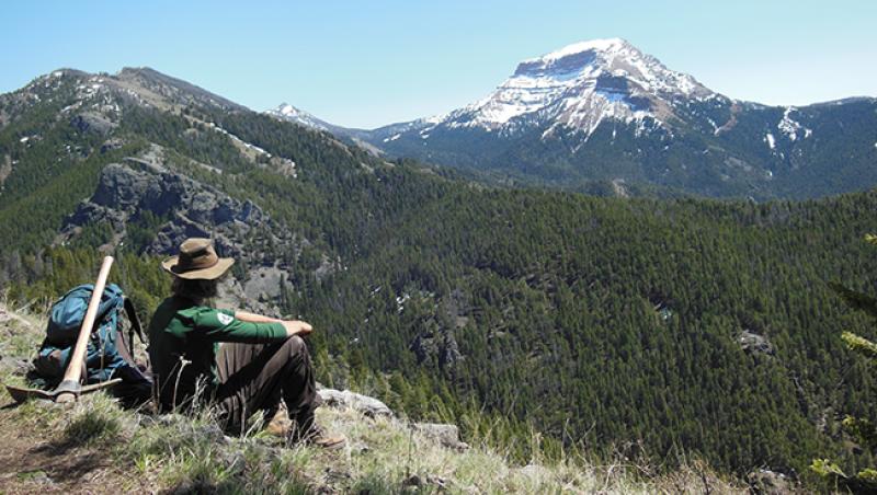 Schoessow sits among the Montana wilderness.