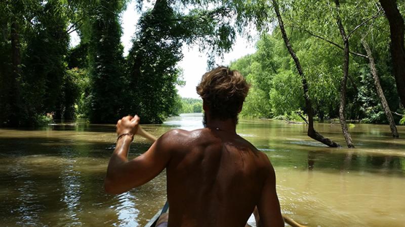 Schoessow paddles a canoe down the Mississippi River.