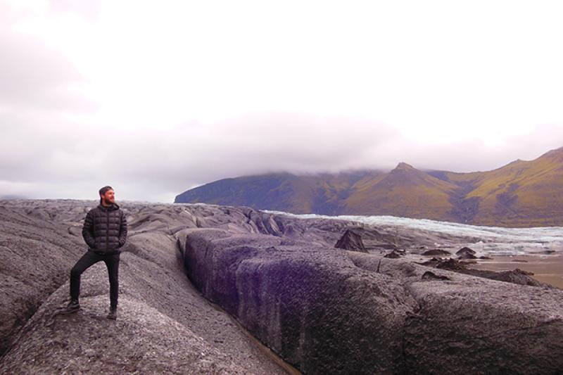 Forrest Schoessow, a PhD candidate in the Department of Geography, stands on a glacier in Iceland in September 2014.
