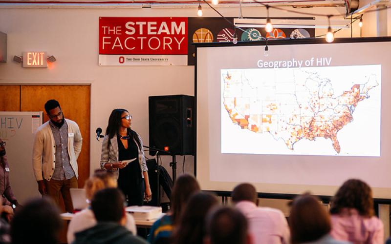 Students conduct presentations on HIV at the STEAM Factory in downtown Columbus.