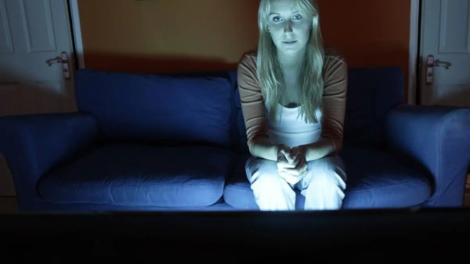 Woman watching TV in the dark
