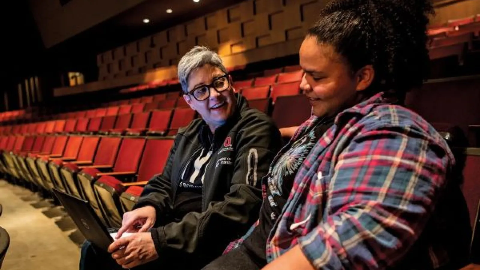 Sherée Greco collaborating with a mentee, student Skylar Kyser, in the Drake Performance and Event Center