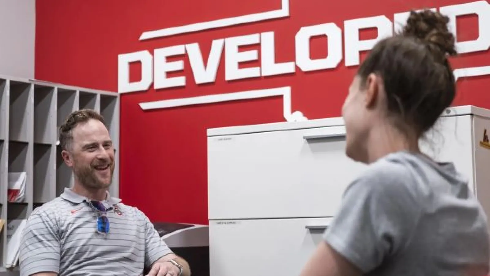 two people talk in an office