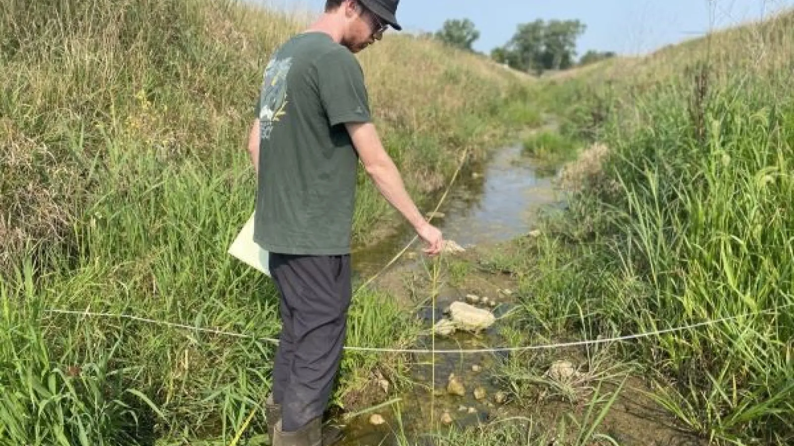 Joe Gentine, a former graduate student at Ohio State’s Aquatic Ecology Laboratory, samples Shallow Run upstream of a U.S. Geological Survey gaging station.