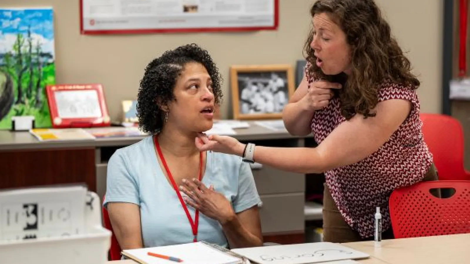 Amber Poindexter, left, and Arin Sheeler, speech therapist and clinical supervisor, practice a pronunciation.