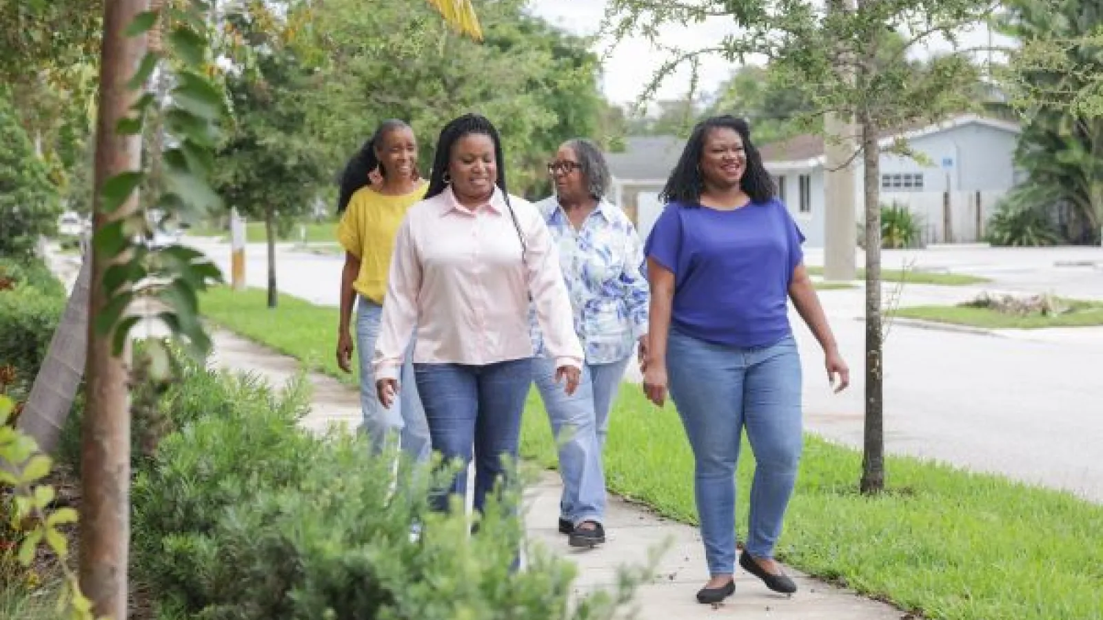 Black women walking through a neighborhood