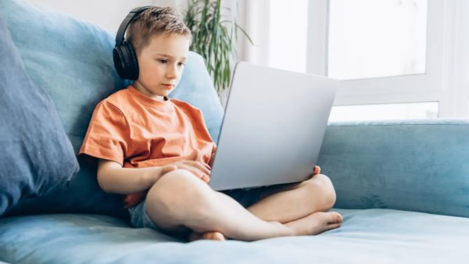 a young child watching a video on a laptop