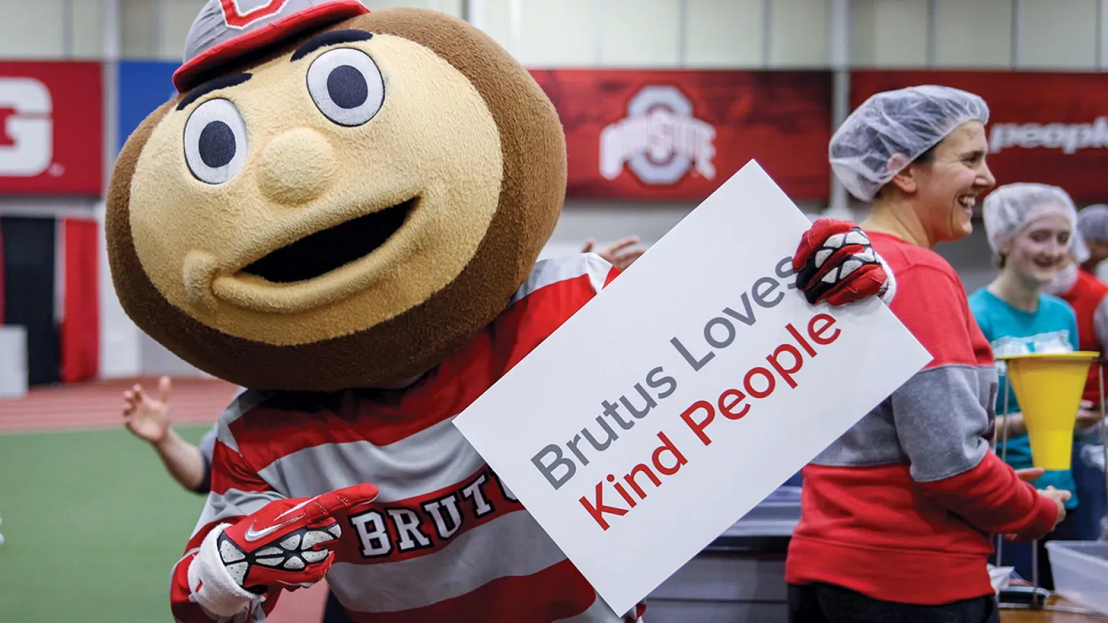 Brutus holding a sign