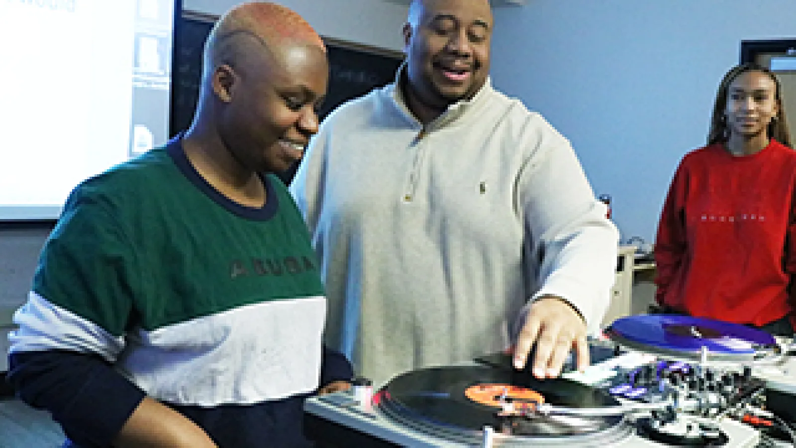 Jason Rawls demonstrates how to scratch on a record for a student