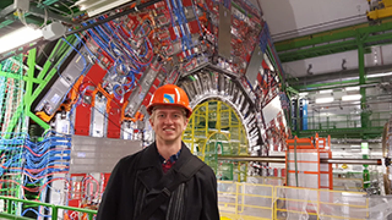 Tony Lefeld, a PhD candidate in the Department of Physics, stands in front of the CMS detector at the Large Hadron Collider at CERN in Geneva, Switzerland.