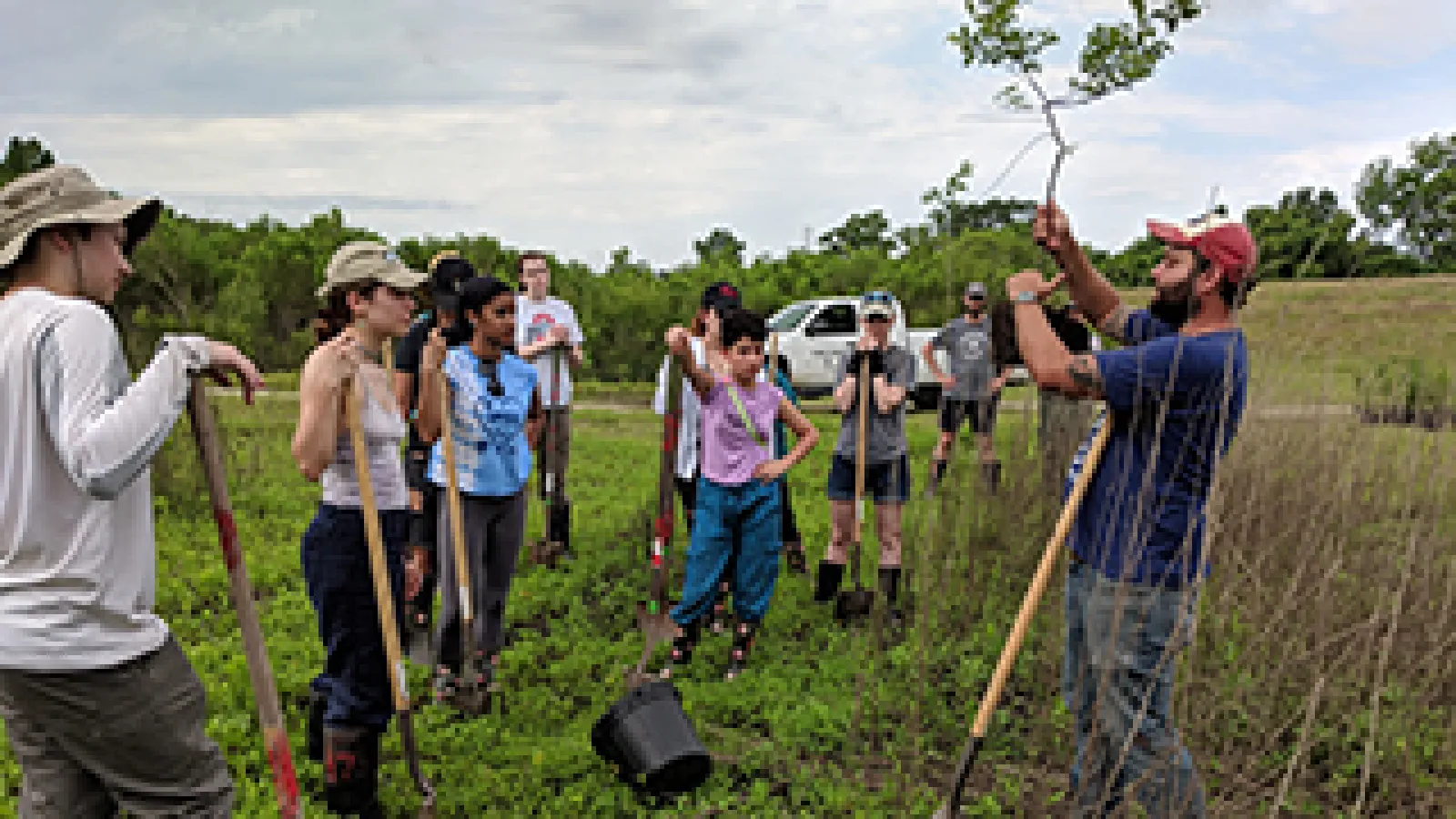 Ohio State students learn about saplings they are about to plant during a field school in southern Louisiana. Photo credit: Mary Thomas