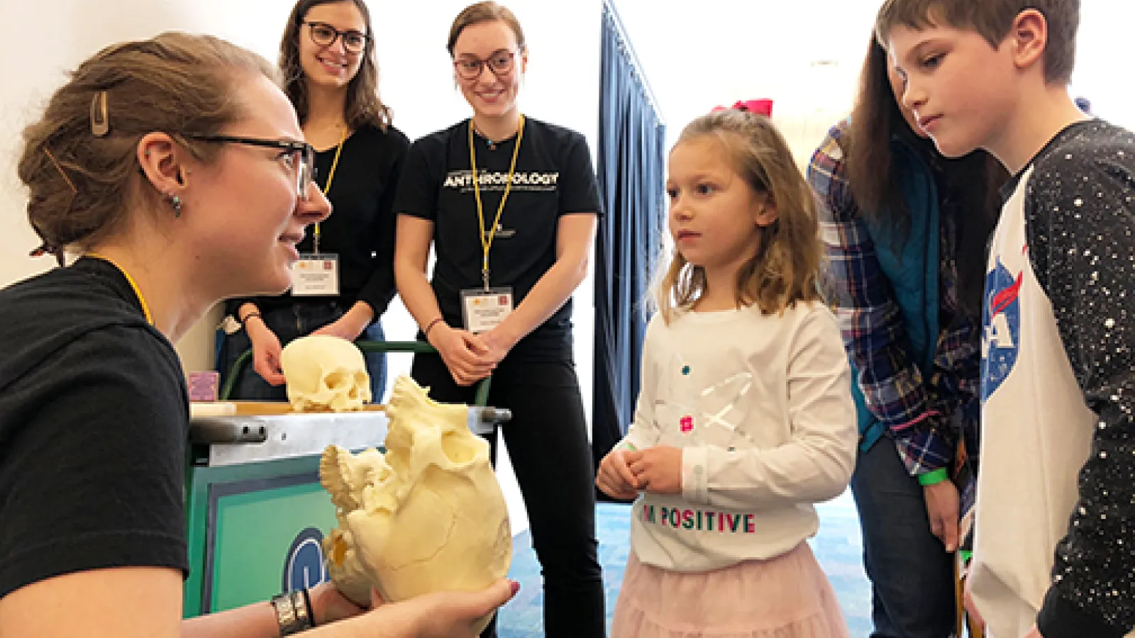 Members of APOP speak with children at COSI