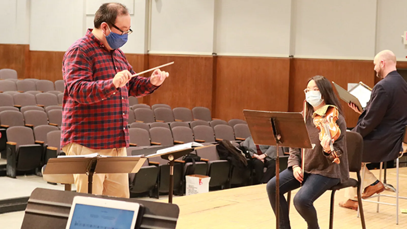 Jae Park conducts during rehearsal.
