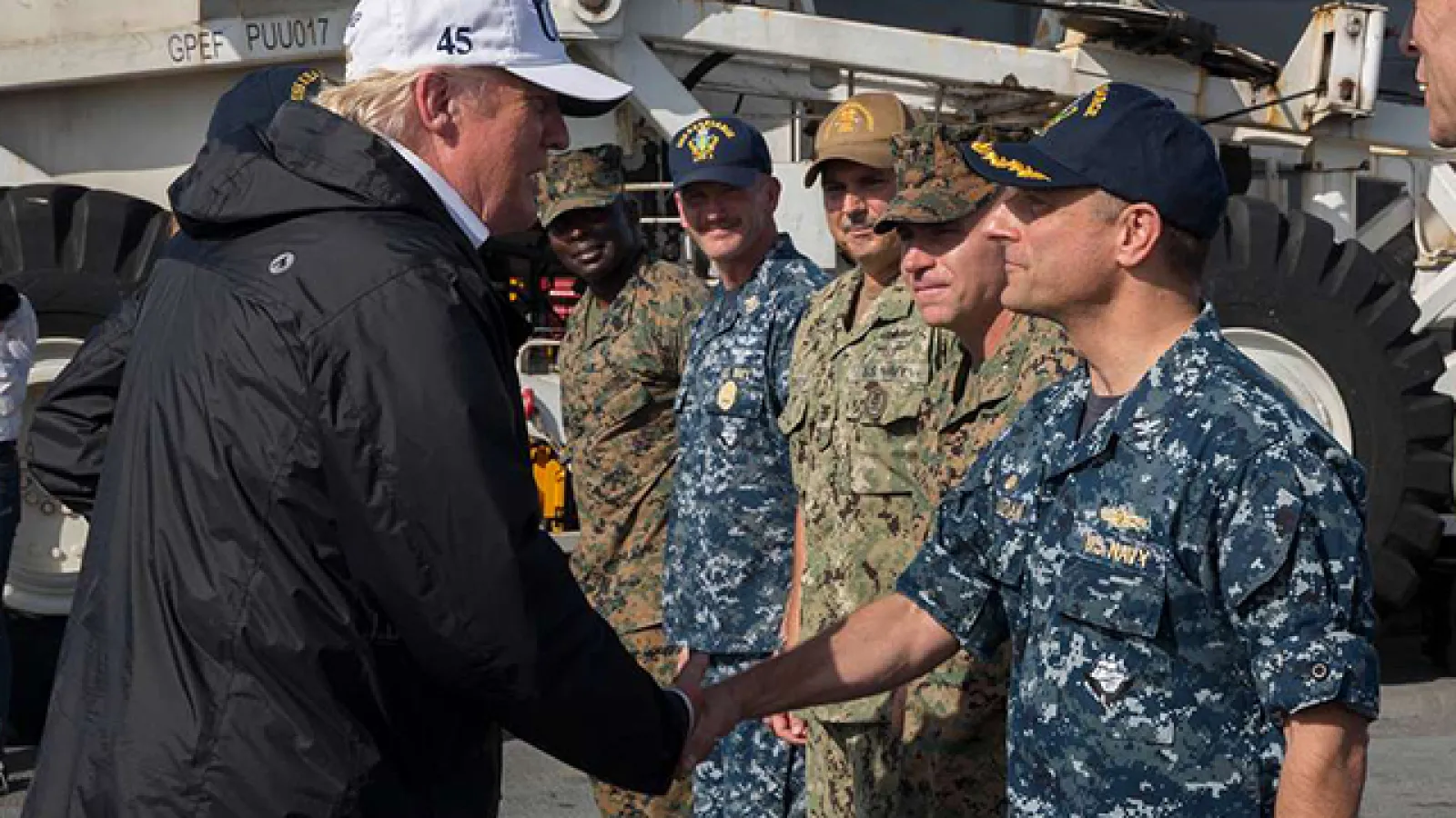 President Donald Trump shakes hands with Capt. David Guluzian of the U.S. Navy