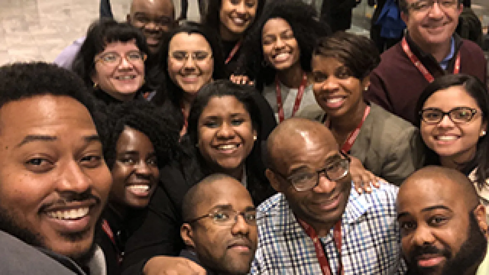 Trevon Logan poses with mentees of the AEA Mentoring Program.
