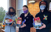 Dani Blumenfield standing with German Club members who are holding donation baskets