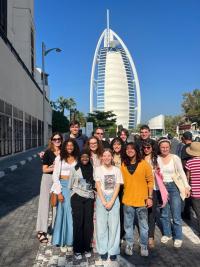 Students in front of a tower in Dubai at COPC28