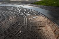 Outdoor architecture, design and branding details of The University Seal on The Oval.