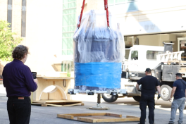 Lead Research Scientist Alexandar Hansen looks on as the massive NMR spectrometer is lowered in the CCIC.