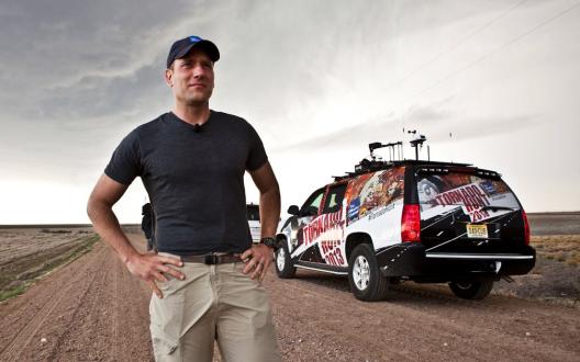 Mike Bettes looks at the sky in front of The Weather Channel Tornado Hunt vehicle