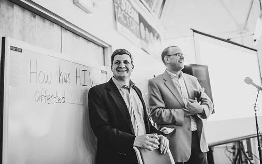 Associate professors Jesse Kwiek (left) of microbiology and Thomas McDow of history at the STEAM Factory for an event that concludes their co-taught course on HIV. Photo courtesy Paul Woo, Wandering Woo Photography