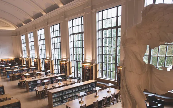 An empty classroom with a large statue at one end