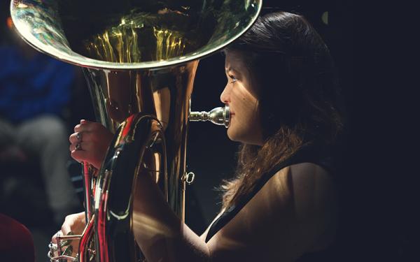 A woman playing a tuba