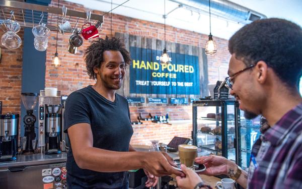 Barista serving coffee