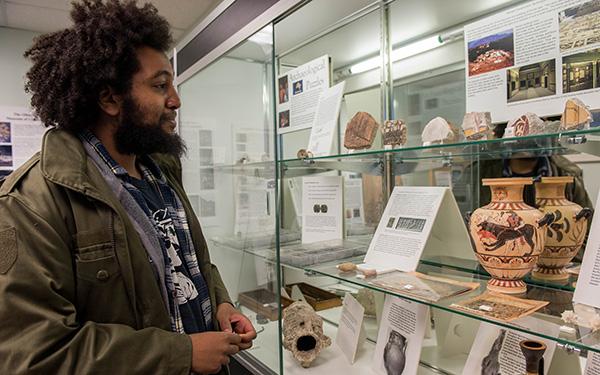 A Black student looking at an anthropology display