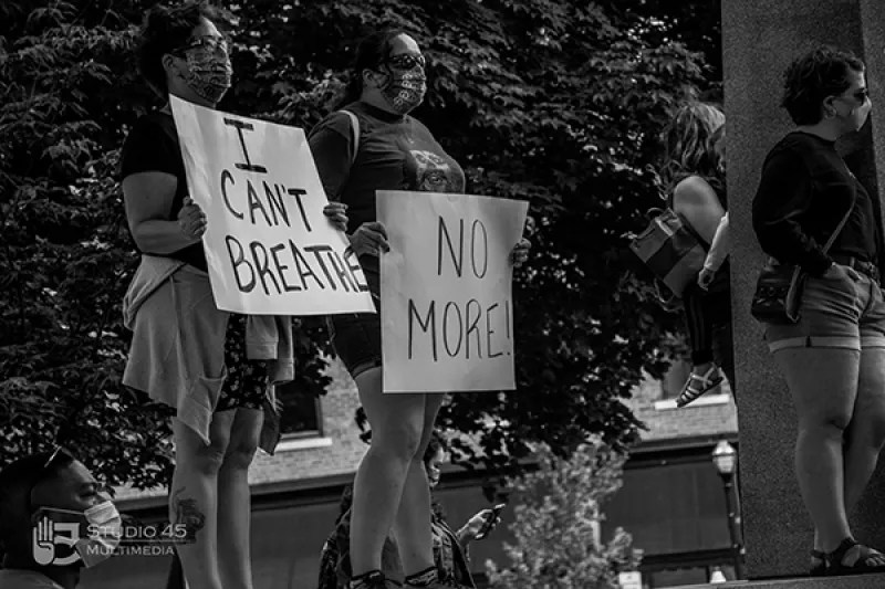 Two protesters hold signs at the Black Lives Matter protest in Mansfield in May 2020
