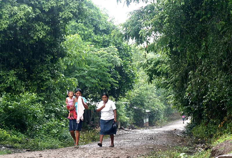 Rural Nicaraguan women walk down a path