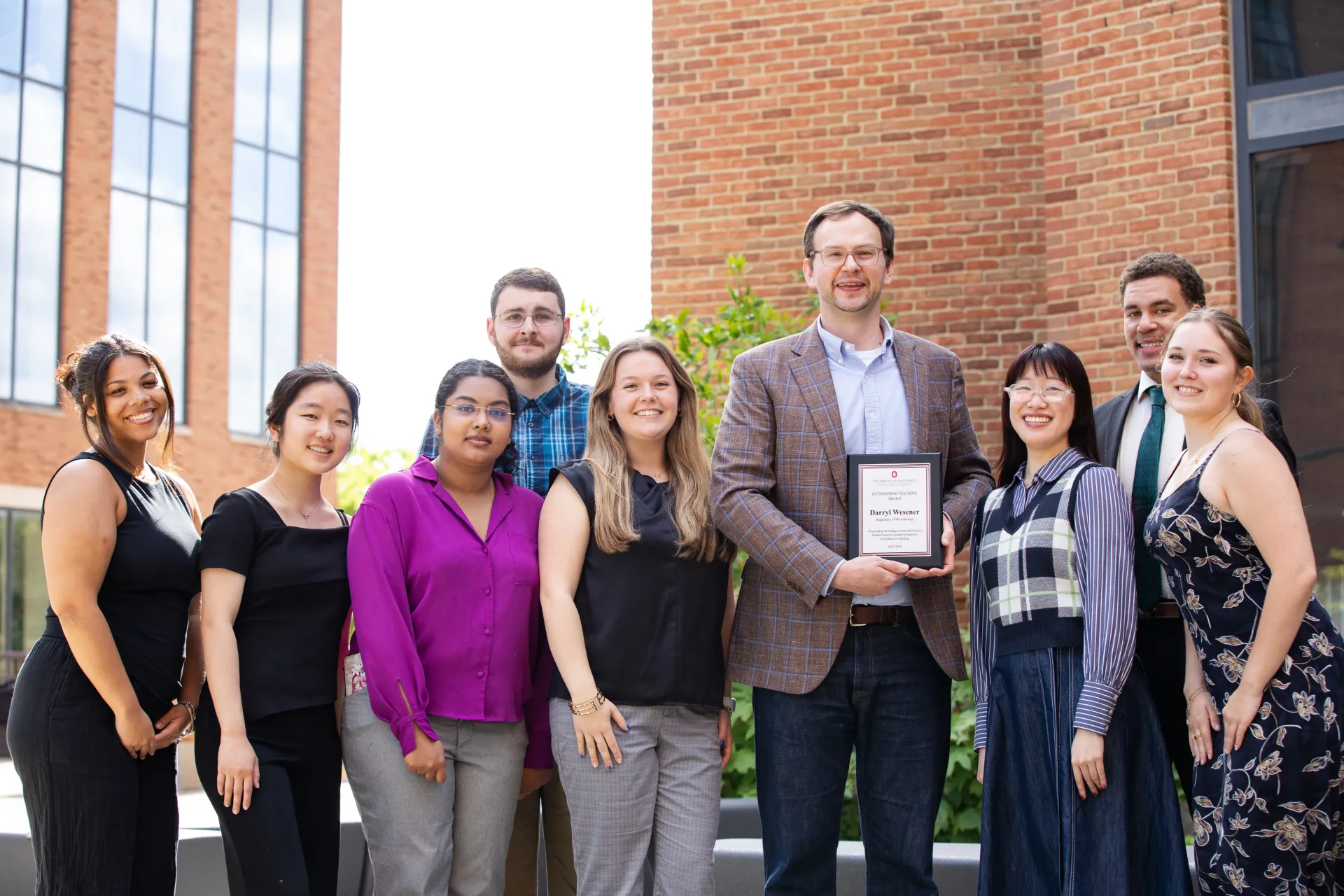 Student Council Members presenting the 2026 Outstanding Teaching Award to Dr. Darryl Wesener, Assistant Professor of Microbiology.