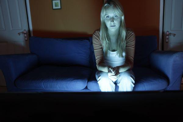 Woman watching TV in the dark
