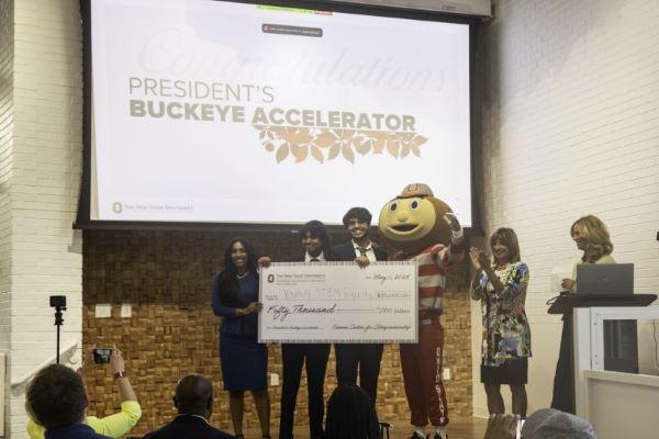 the Youth for STEM Equity team receives a large award check