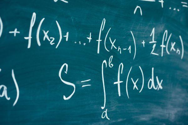 a chalkboard showing calculus formulas