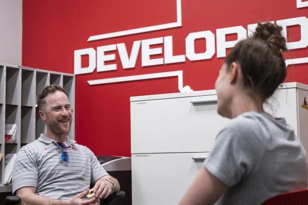 two people talk in an office