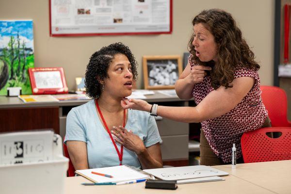 Amber Poindexter, left, and Arin Sheeler, speech therapist and clinical supervisor, practice a pronunciation.