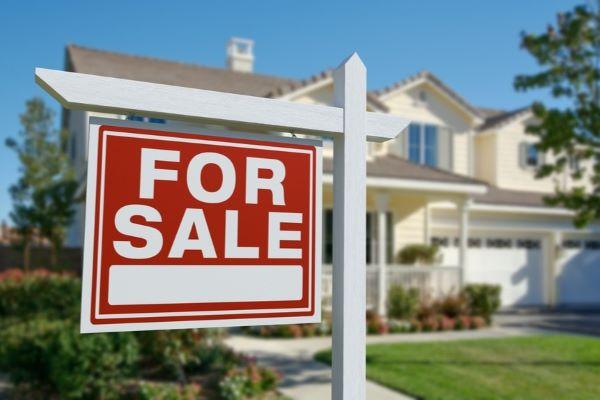 for sale sign in front of a home