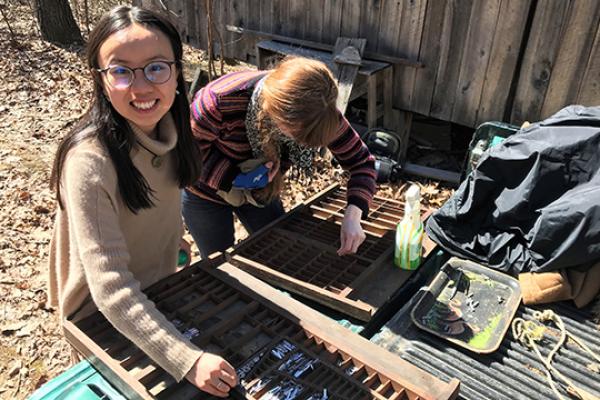 Luna Luo (left) and Molly Rideout (right), students from the 2018 Ohio Field School class, clean and sort type for their service project, which involved assisting with the restoration of Bloody Twin Press.